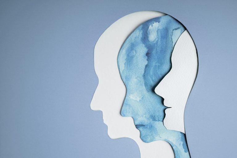 multiple cutout images of a head, concept of mental health and bipolar disorder