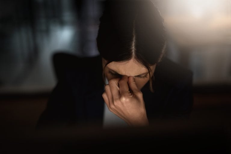 Stressed Woman Works Late In Office